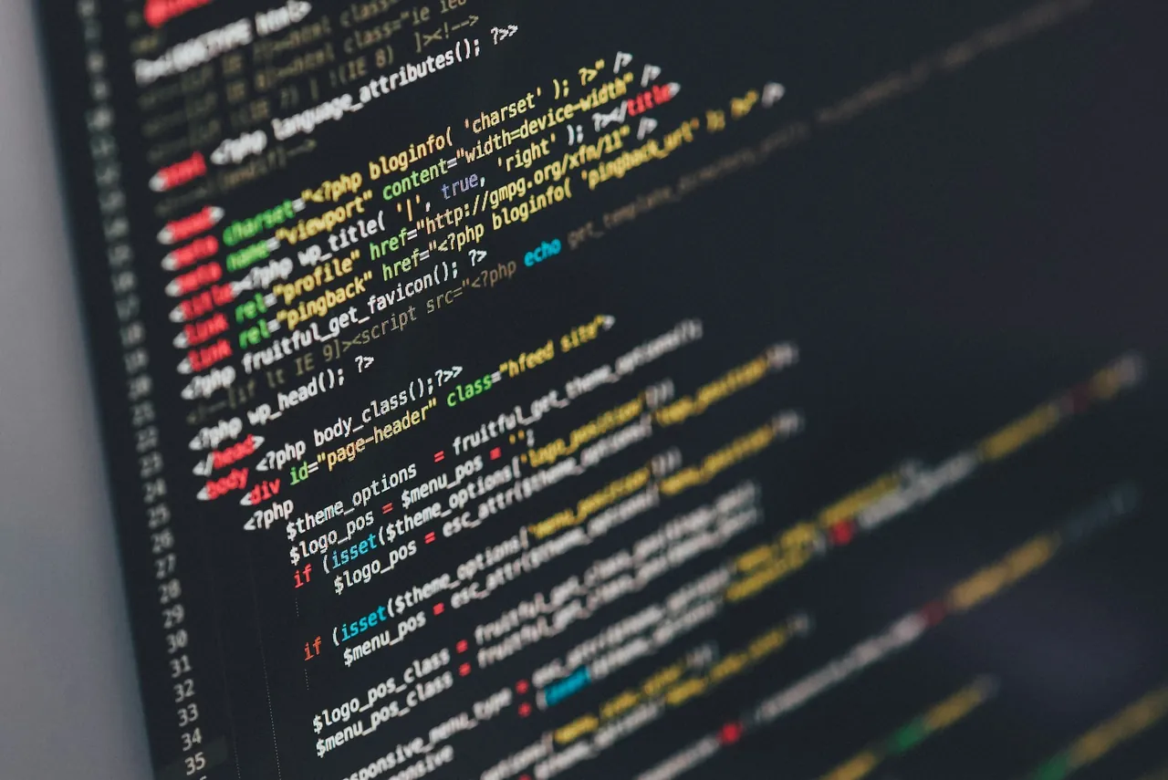 Developer working with code on multiple screens